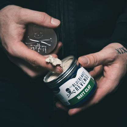 The Bluebeards Revenge Matt Clay Hair Styling Product being scooped into a man's hands