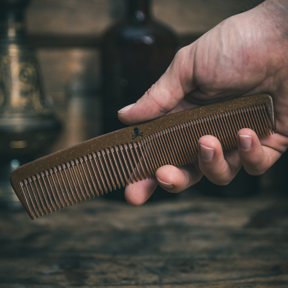 Liquid Wood Plastic Free Hair Styling Comb in a man's hand by The Bluebeards Revenge