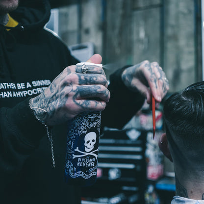 bluebeards revenge water spray bottle being used on a man's hair in a barbershop